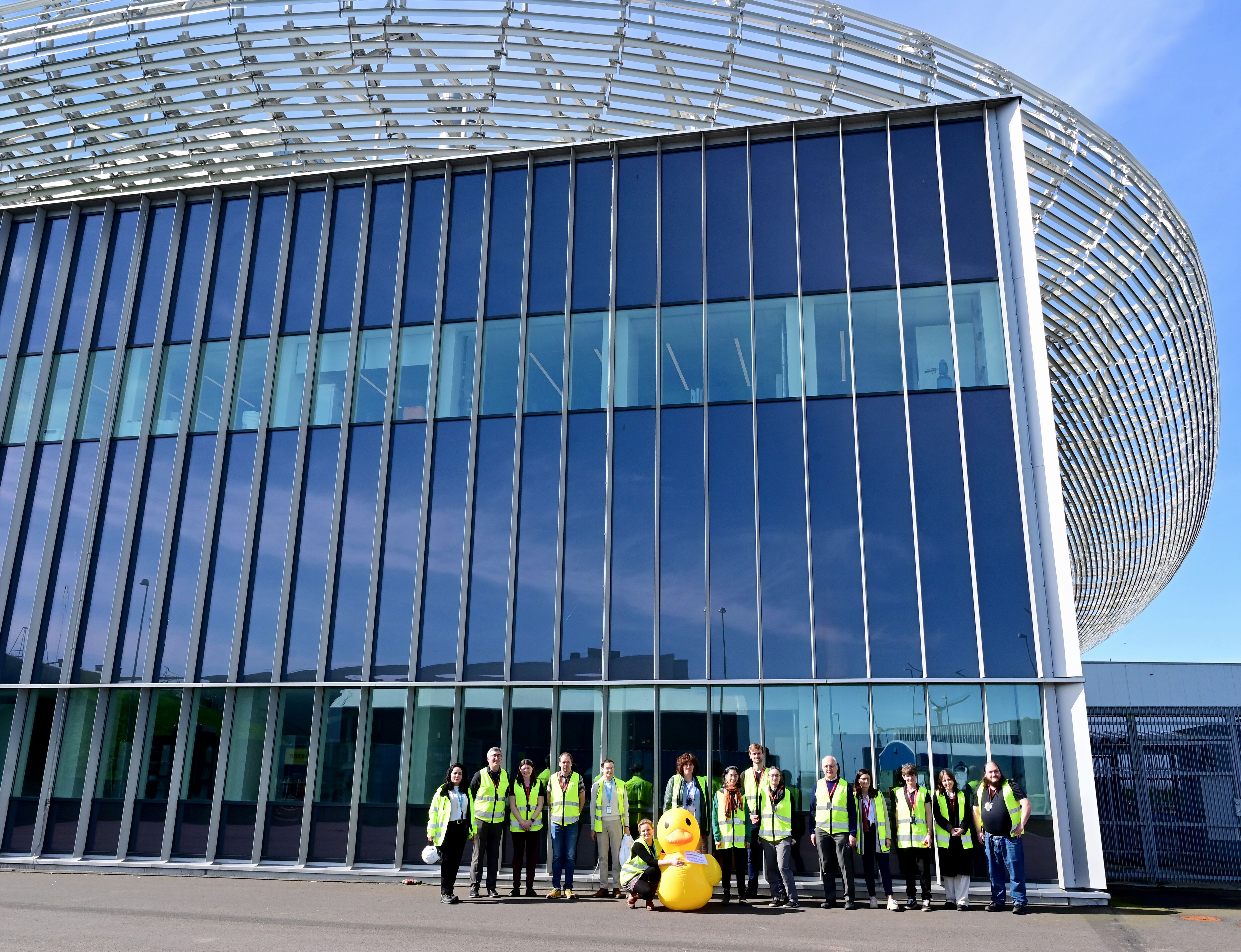 Symposium attendees outside the ESS with Rupert, a giant rubber duck