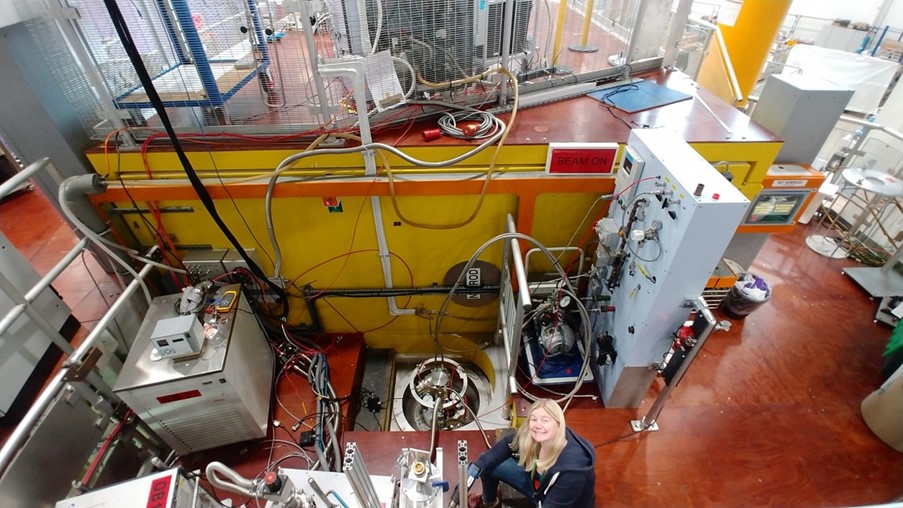 A lady smiling, looking up from the Nimrod instrument