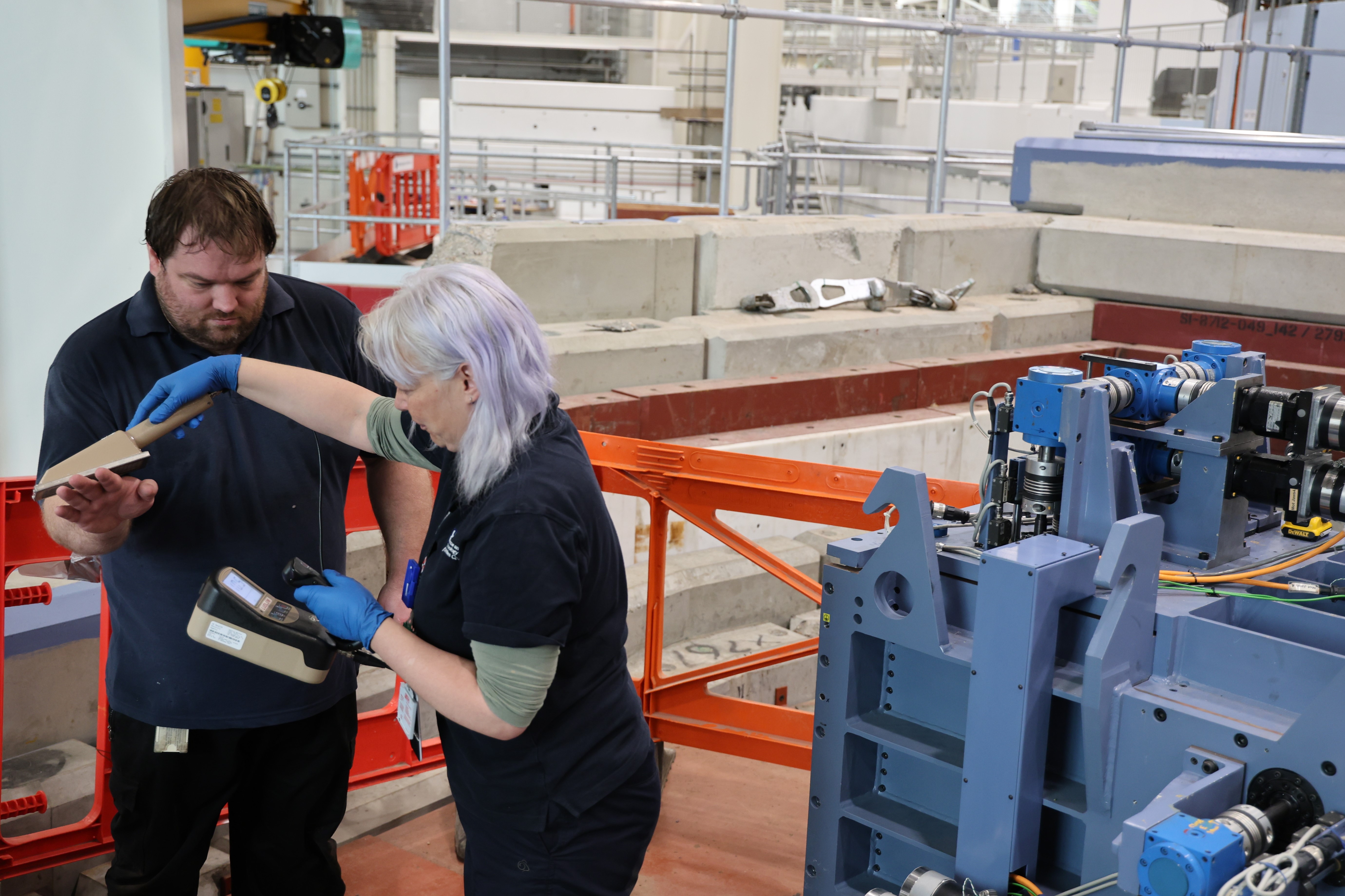 A woman holding a sensor next to a man's hands