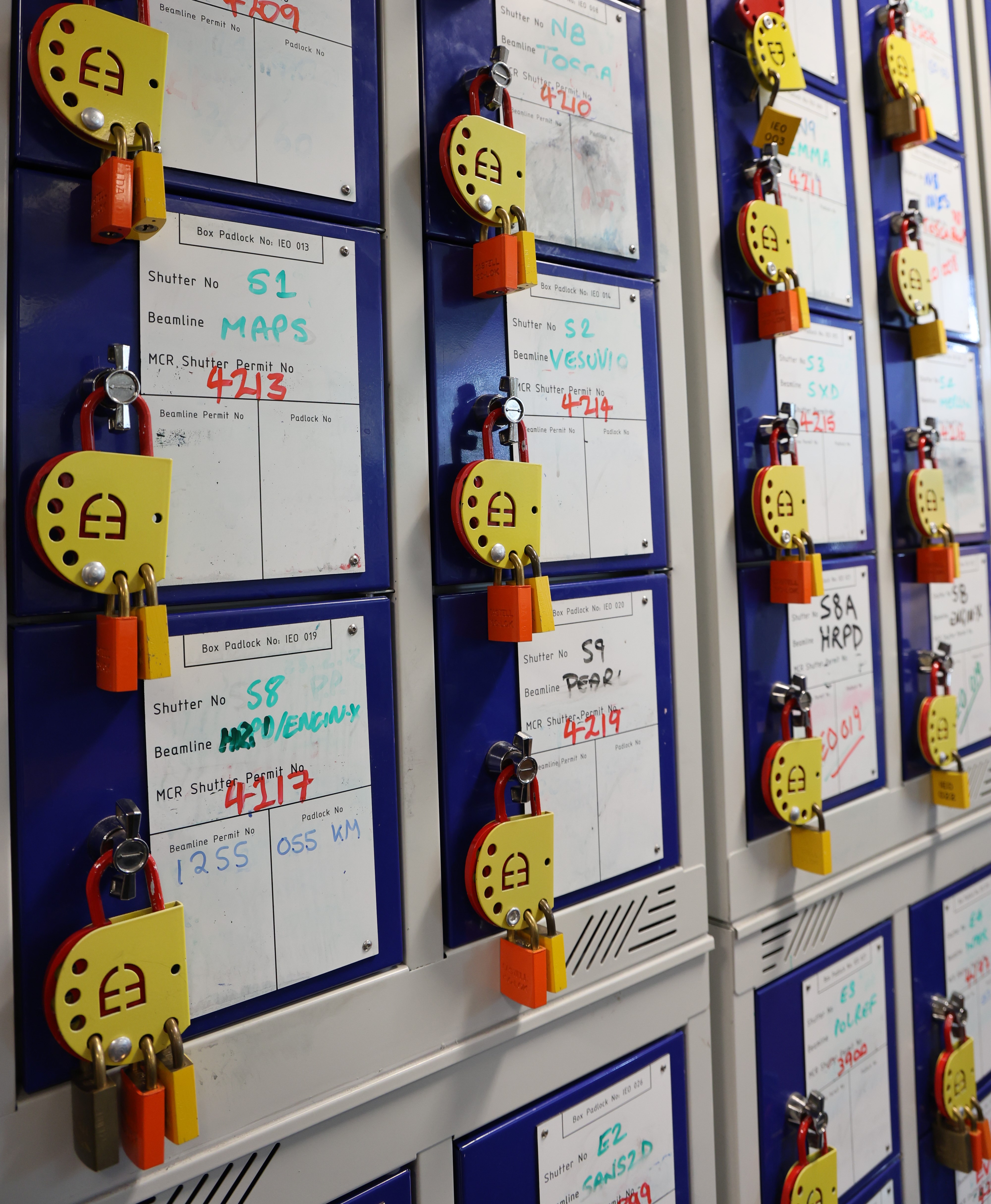 A wall of small boxes with padlocks on