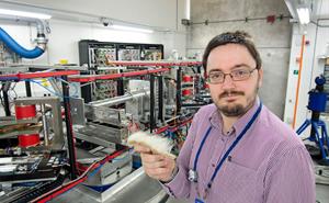 STFC scientist Dr Adam Washington with the sample of polar bear currently under examination at ISIS Neutron and Muon Source. (Credit: STFC)​