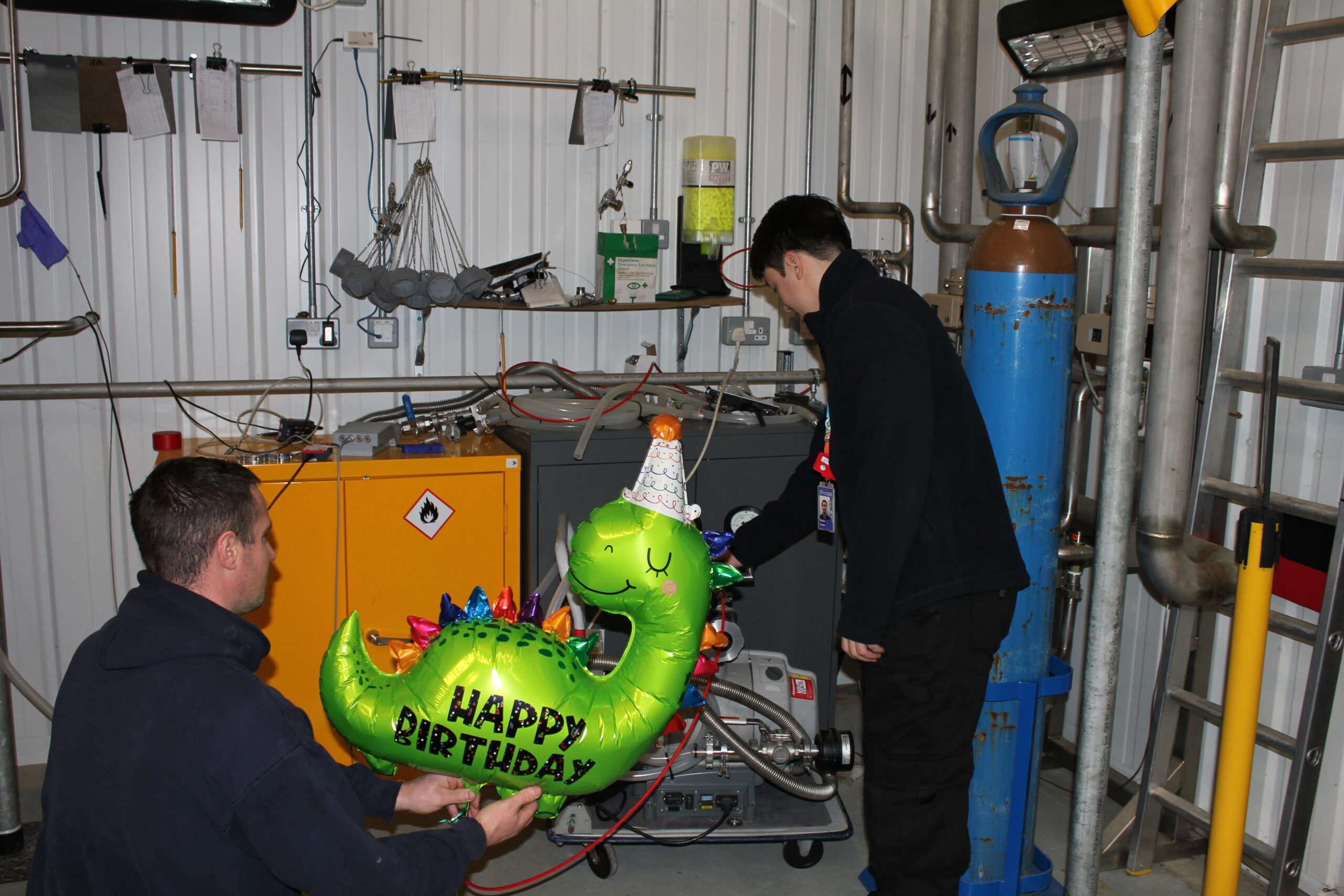 Picture of Dale and Mulder from the ISIS Helium Recovery Team emptiying the first balloon into the recycling system.