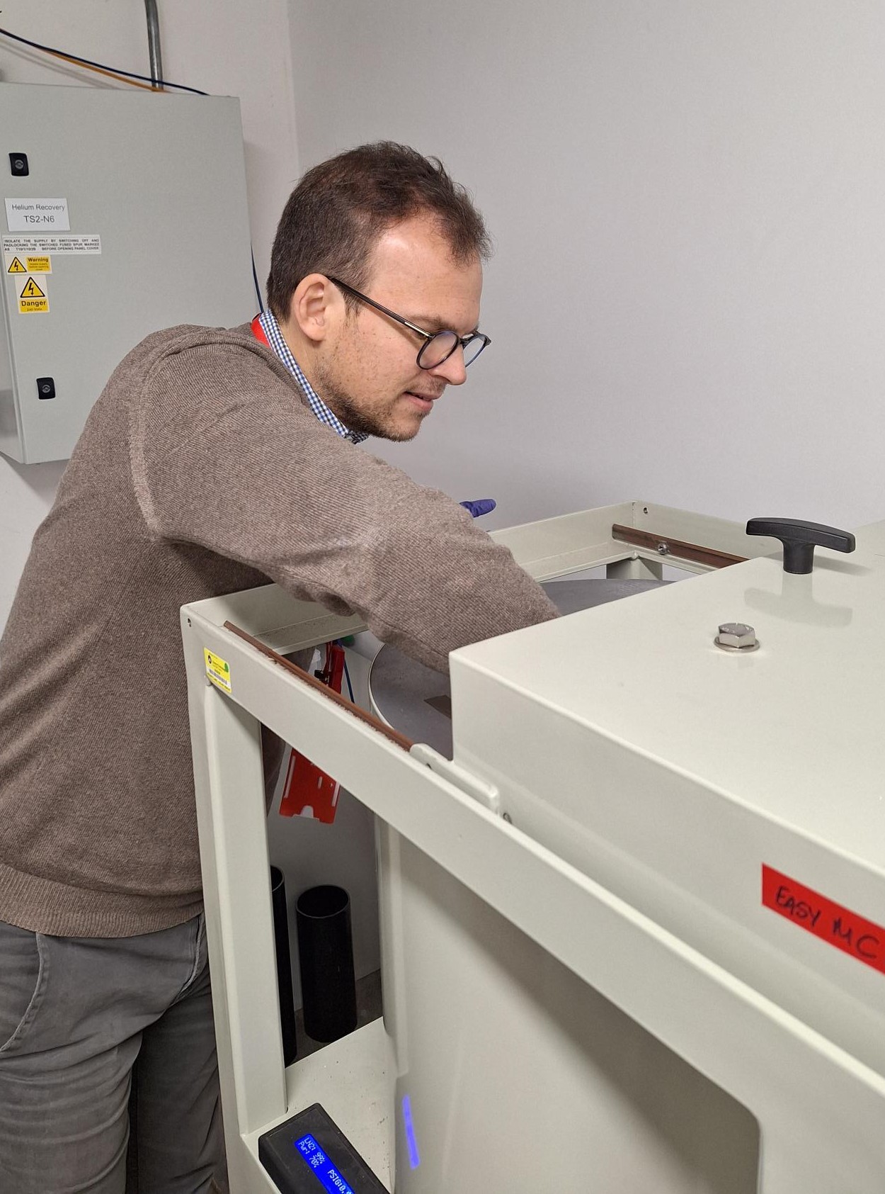 Luca Pattavina loading a crystal sample into a germanium detector to test which radioisotopes are present after irradiation on ChipIr.