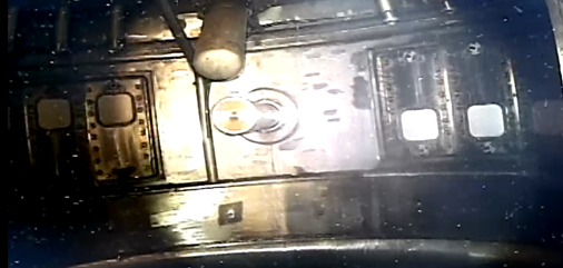 Grainy photo of the inside of the void vessel showing light reflecting from complex machinery